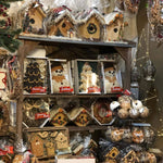 Shelves of seed-covered birdhouses and bird seed treats