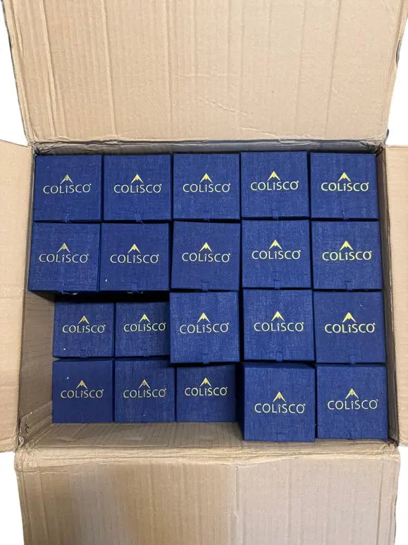 Shipping carton filled with rows of navy ornament gift boxes