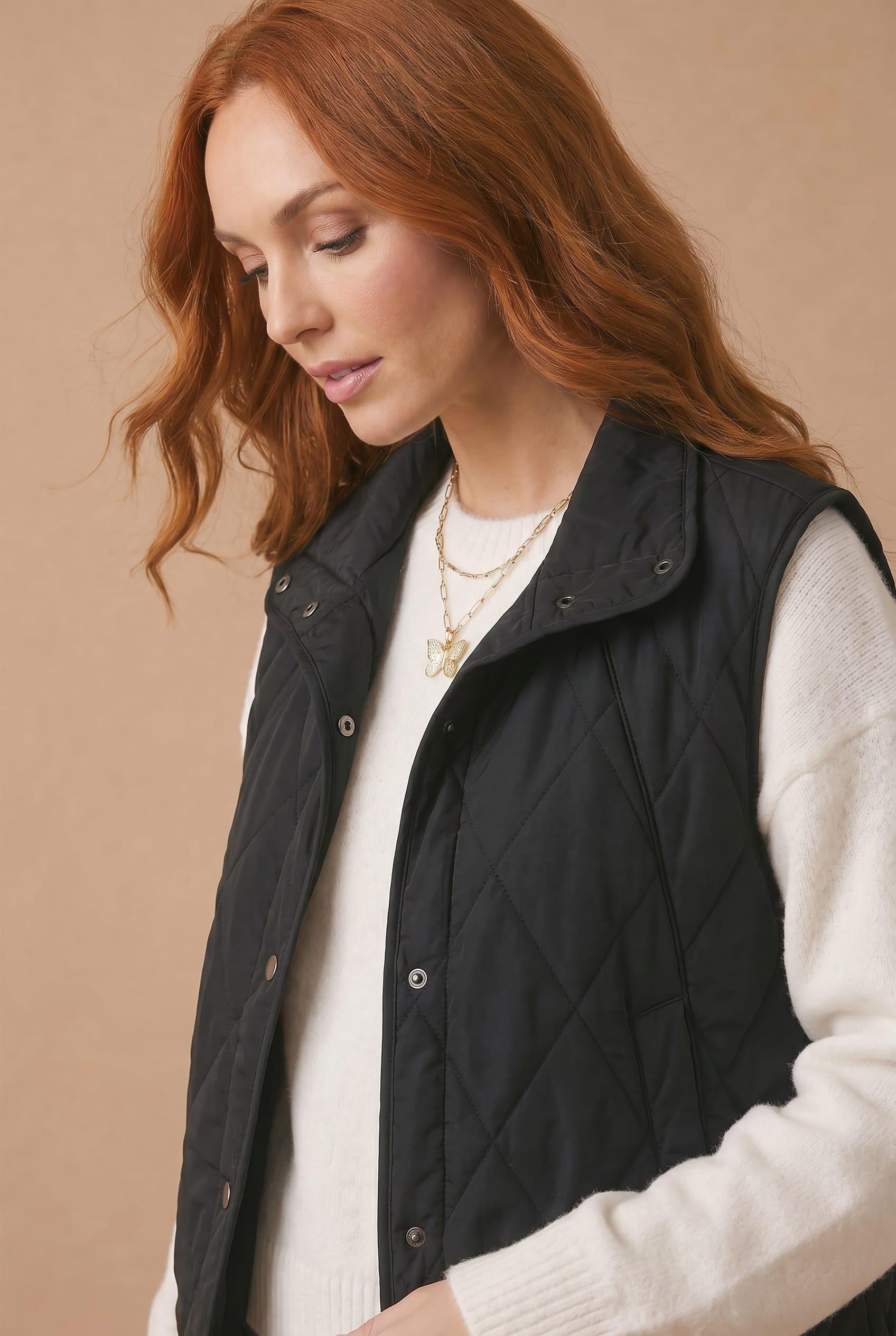 High Neck Snap Button Quilted Puffer Vest in Black - close-up of quilting