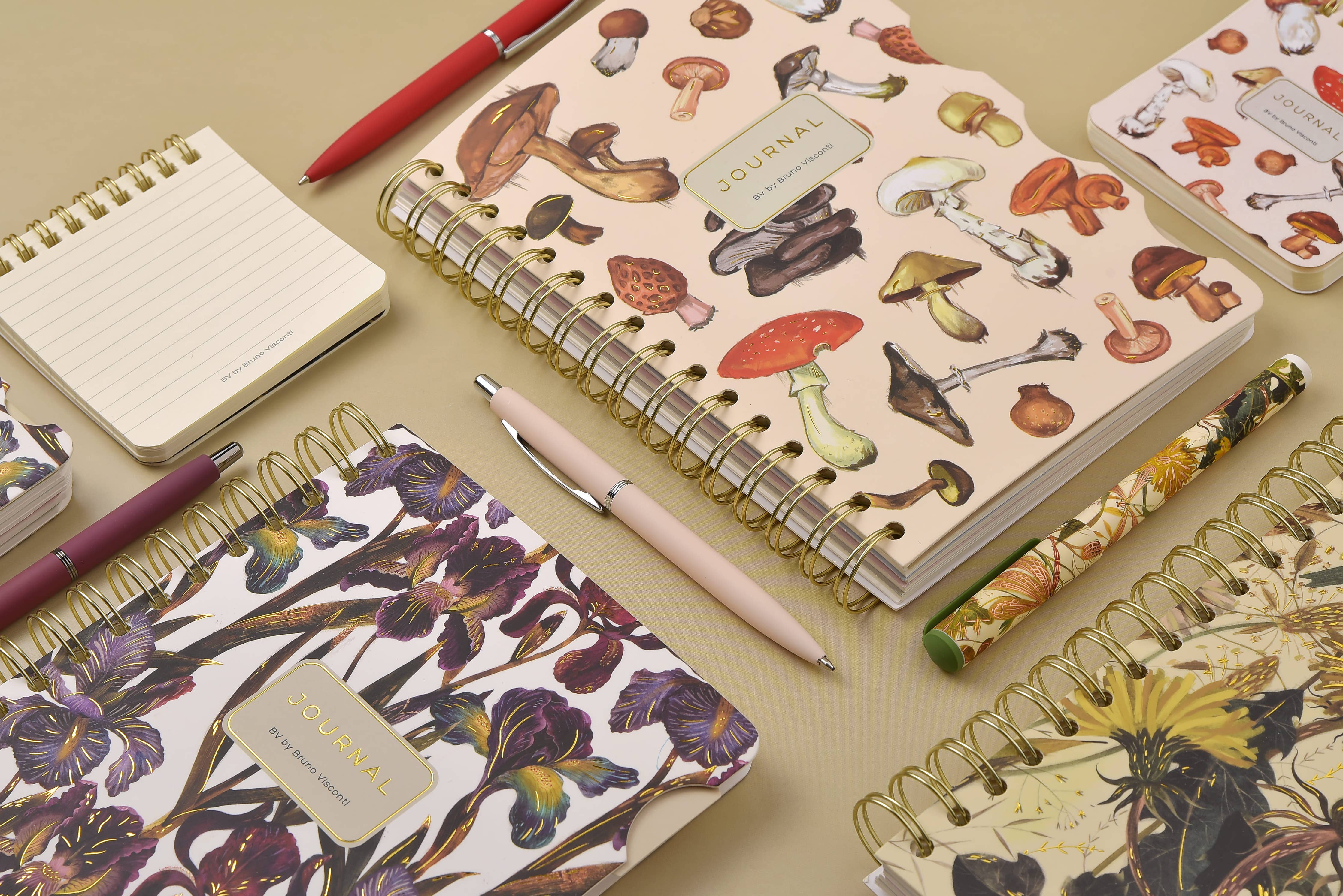 Spiral-bound art journal with a painted iris cover, interior pages