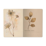 A5 ruled notebook with a blush and gold floral cover design, detail view