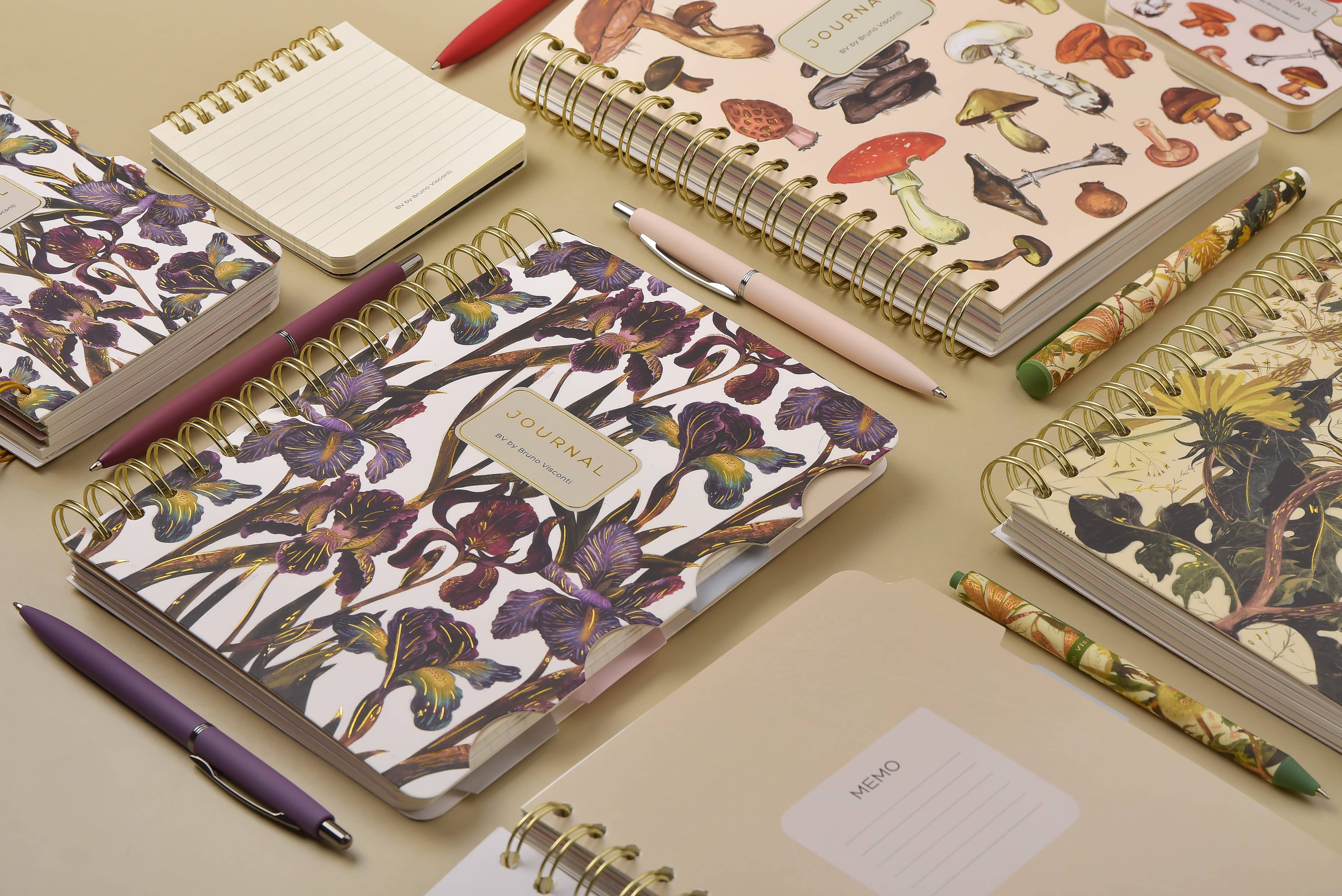 Spiral-bound art journal with a painted iris cover, interior pages