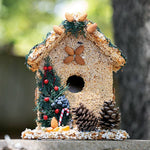 Juniper seed birdhouse with pine cones and evergreen trim outdoors