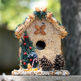 Juniper seed birdhouse with pine cones and evergreen trim outdoors