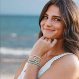 Reflect hair tie bracelet set in beachy neutrals and green with gold wave charm, view 2