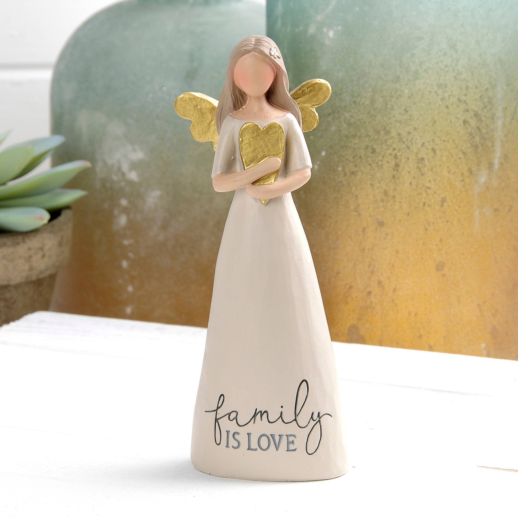Angel figurine holding a gold heart