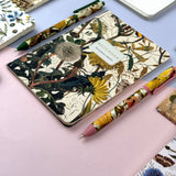 A5 ruled notebook with a green botanical cover design, detail view