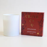 Applewood candle in matte white vessel