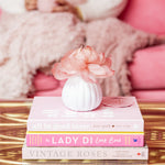 Sweet Grace Flower Diffuser styled on stacked books atop a gold side table in a living room