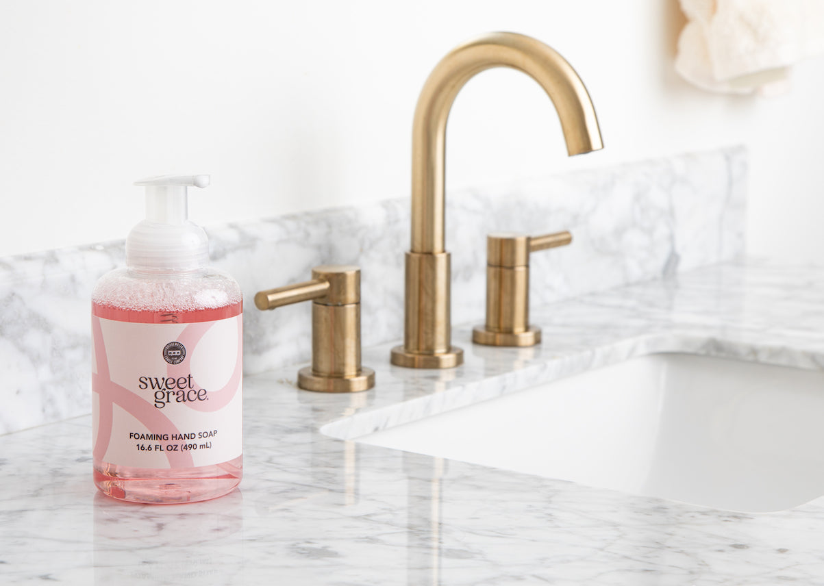 Bridgewater Sweet Grace foaming hand soap on a marble bathroom countertop beside a brass faucet