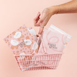 Hand tucking a Bridgewater Sweet Grace mod stripe sachet into a pink wire basket