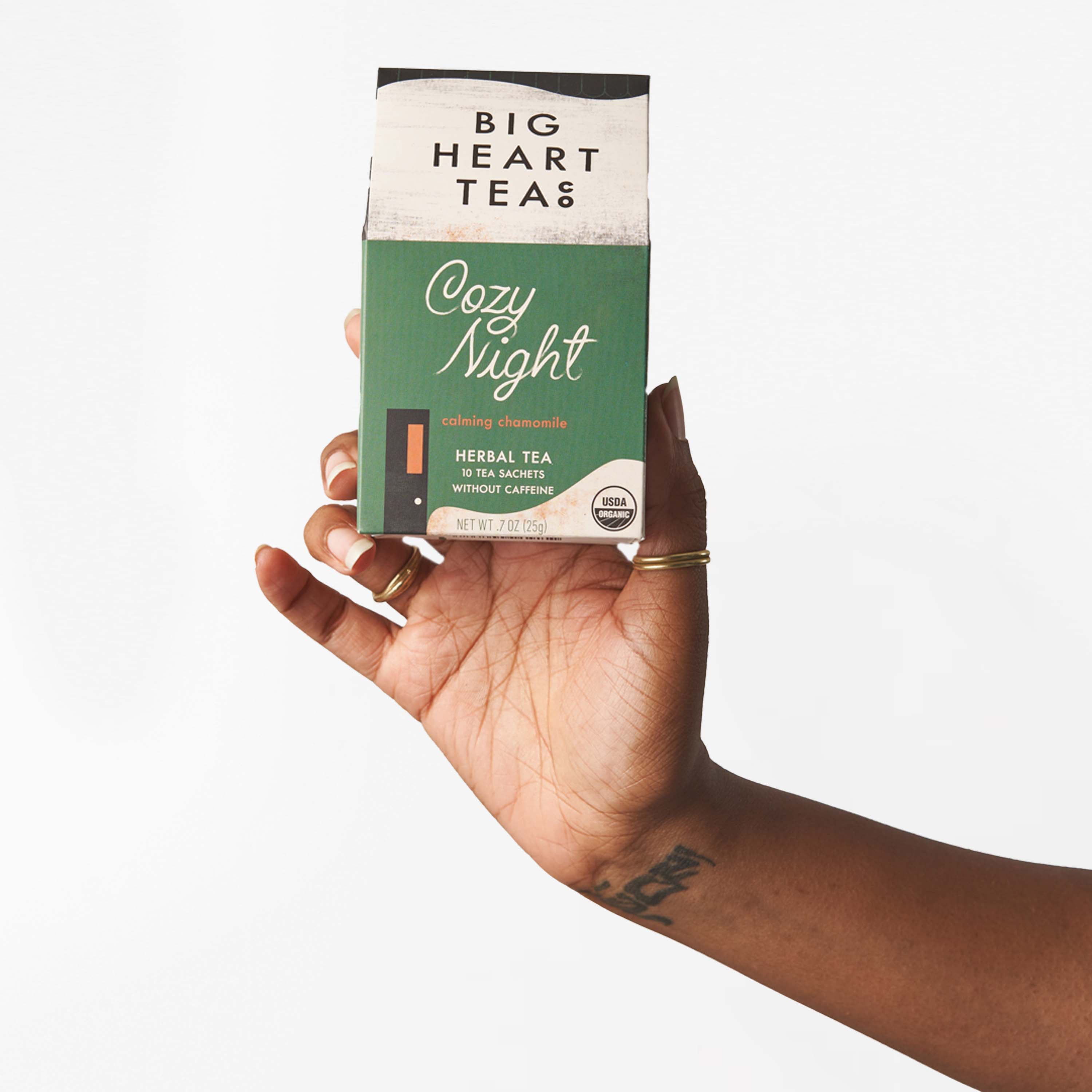 Hand holding a Cozy Night herbal tea box