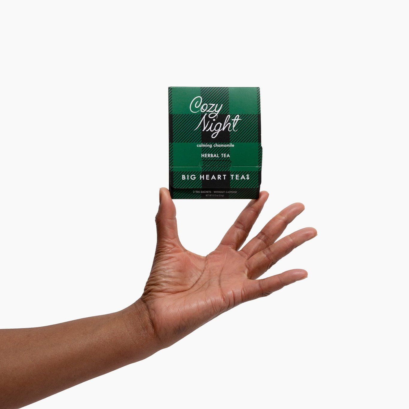 Cozy Night caffeine-free herbal tea box held in an open hand