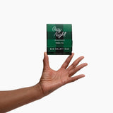 Cozy Night caffeine-free herbal tea box held in an open hand