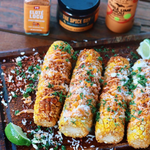 Grilled street corn topped with cheese, chili powder and Chile Lime Aioli