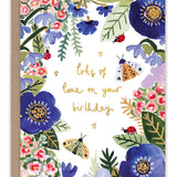 Bugs & Flowers Birthday Card — front: a border of blue anemones, pink blossoms, ladybugs and moths around gold foil "lots of love on your birthday"