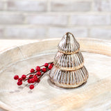 Small tiered gold mercury glass tree beside a red berry sprig on a whitewashed wood tray