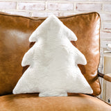 White faux fur Christmas tree-shaped pillow on a cognac leather chair