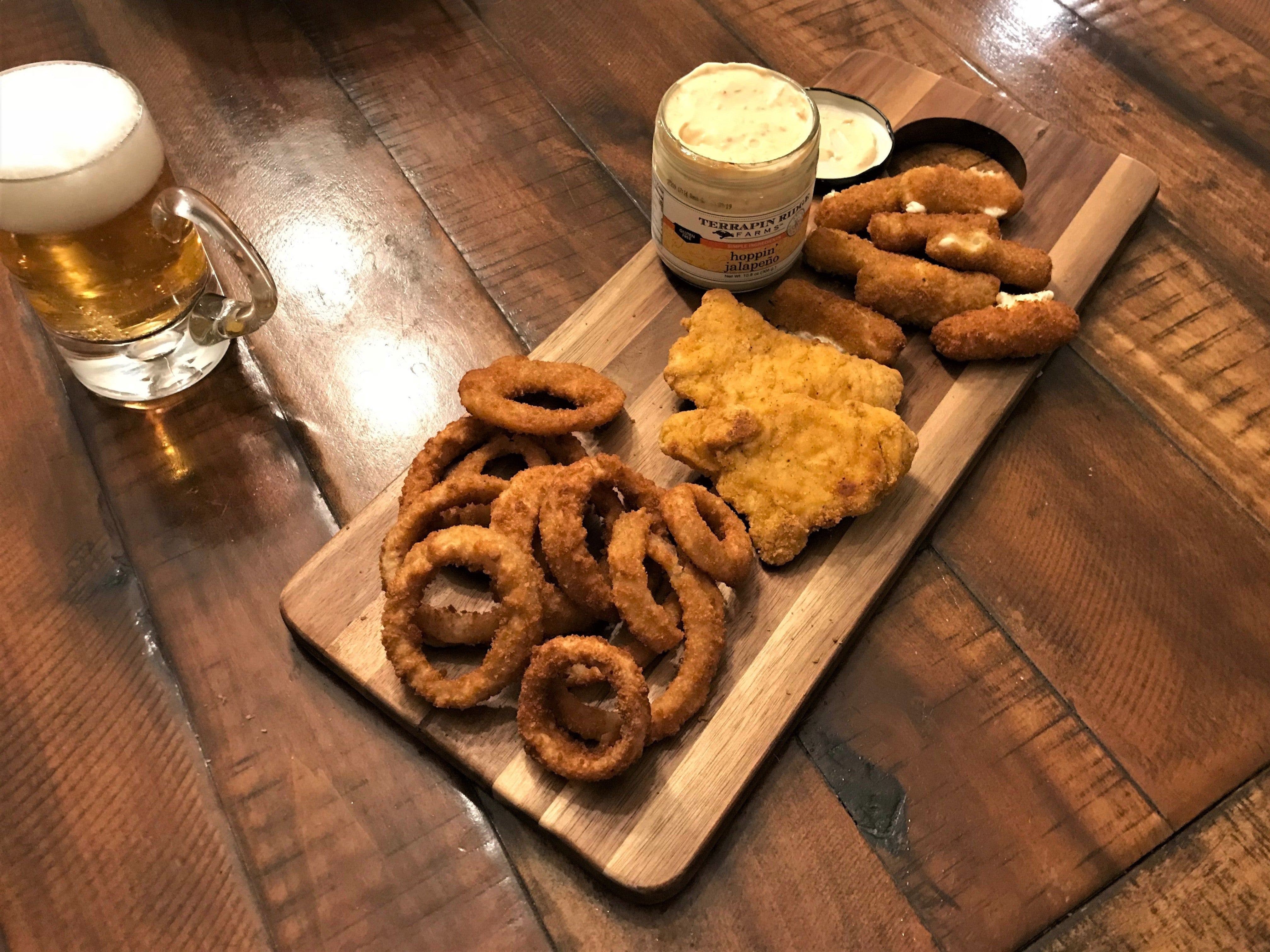 Platter of onion rings, chicken and mozzarella sticks served with Hoppin' Jalapeño Dip