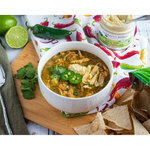Chicken chili with jalapeños and tortilla strips beside Hatch Chile Cream Cheese Dip