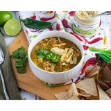 Chicken chili with jalapeños and tortilla strips beside Hatch Chile Cream Cheese Dip
