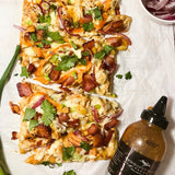 Chicken bacon flatbread pizza drizzled with Sweet Heat Grill & Wing Sauce
