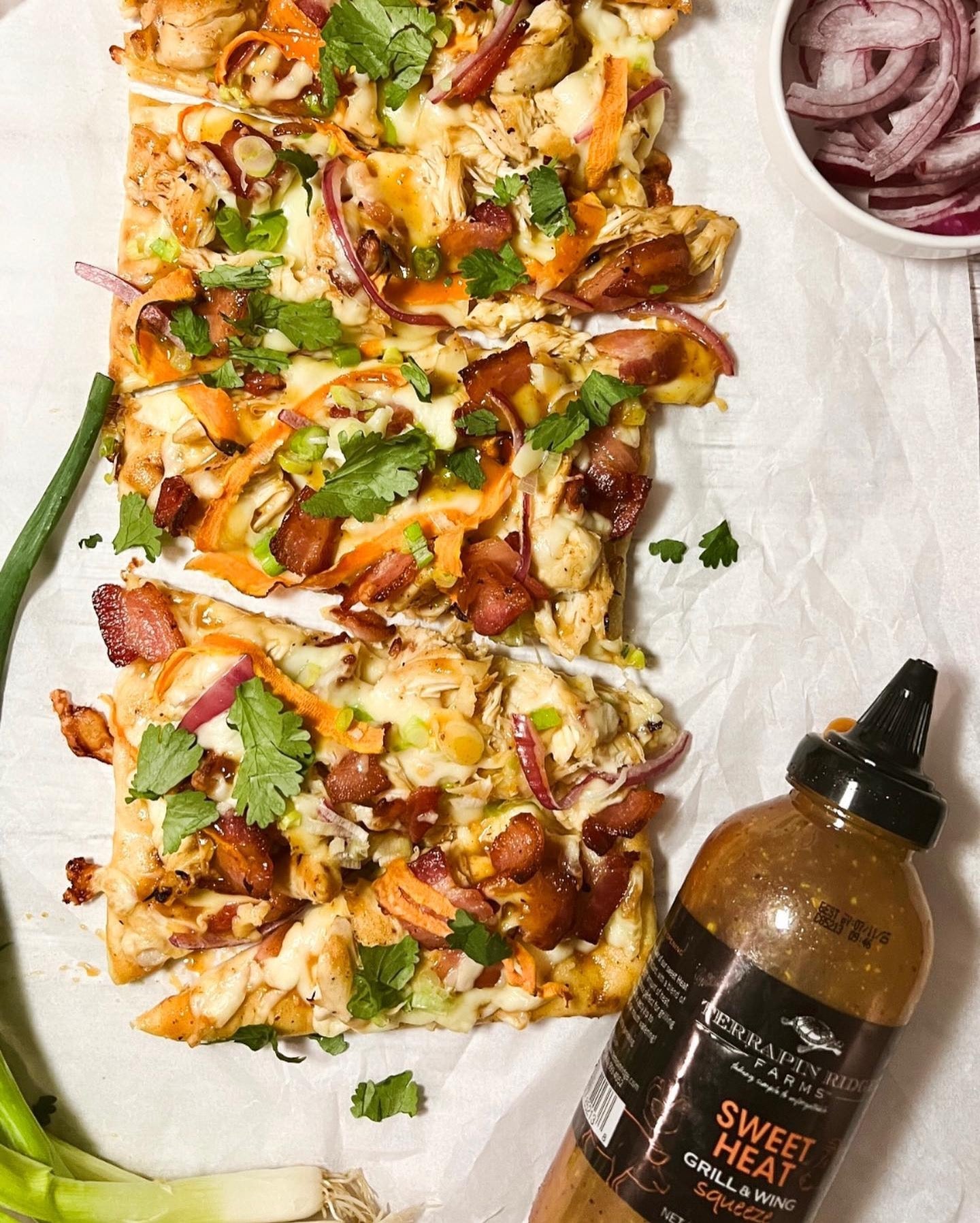 Chicken bacon flatbread pizza drizzled with Sweet Heat Grill & Wing Sauce