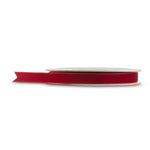 Spool of half-inch burgundy velvet ribbon partly unrolled