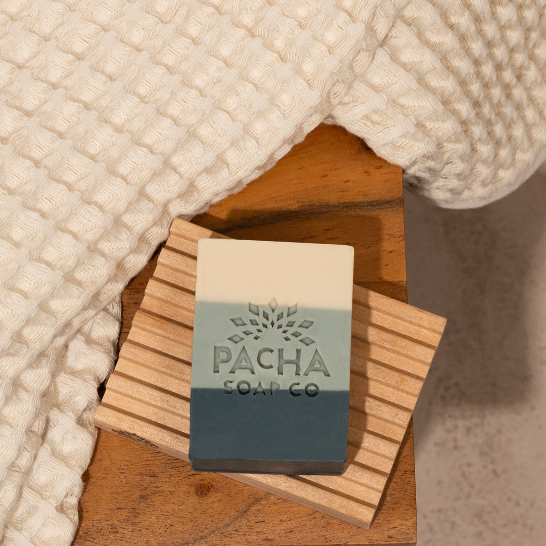 Natural wood bar soap dish holding a bar of soap