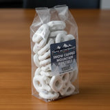 A clear plastic package containing white yogurt pretzels with a blue label that reads 'Snow Capped Mountain Pretzels, Yogurt, 4.5 ounces (125g)'.