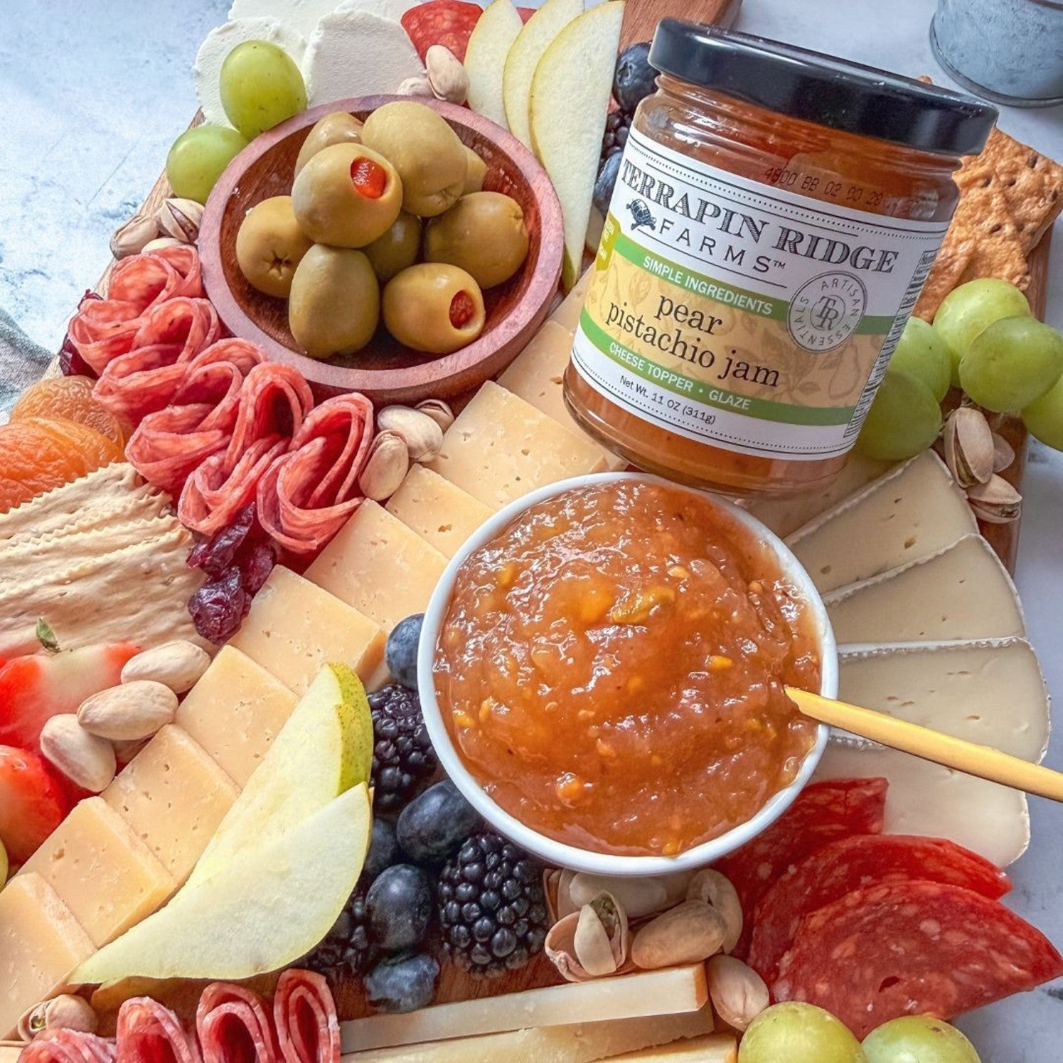 Pear Pistachio Jam on a charcuterie board with cheeses, salami, fruit and pistachios