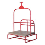 Red metal ski lift chair ornament with a light wood seat and hanging bar
