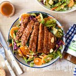 Sesame chicken salad with vegetables, oranges and almonds dressed with Ginger, Miso & Honey Dressing