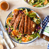 Sesame chicken salad with vegetables, oranges and almonds dressed with Ginger, Miso & Honey Dressing