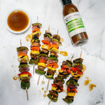 Pepper, onion and mushroom skewers with a bowl of Ginger, Miso & Honey Dressing