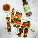 Pepper, onion and mushroom skewers with a bowl of Ginger, Miso & Honey Dressing