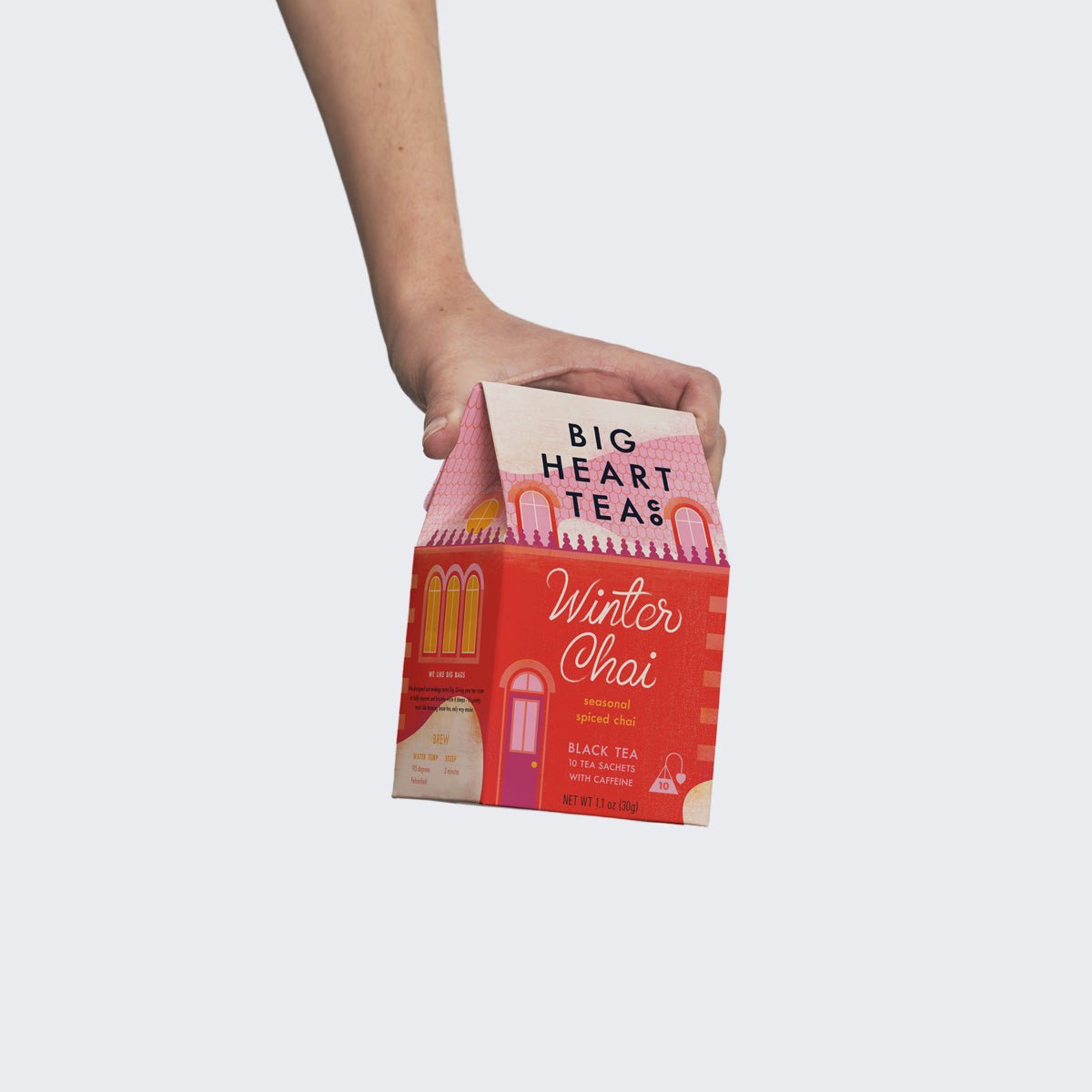Hand holding a Winter Chai 10-count tea box