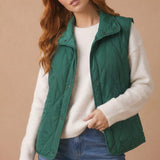 High Neck Snap Button Quilted Puffer Vest in Hunter Green - hands in pockets
