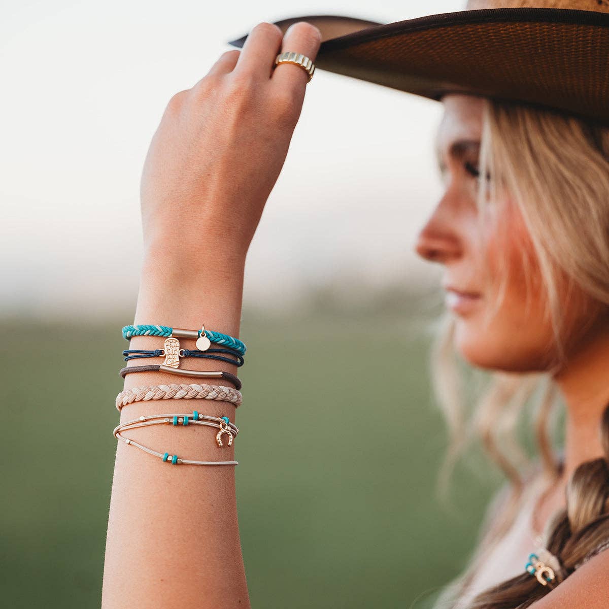 Stride hair tie bracelet set in blue, brown, cream and teal with gold cowboy boot and horseshoe charms, view 5