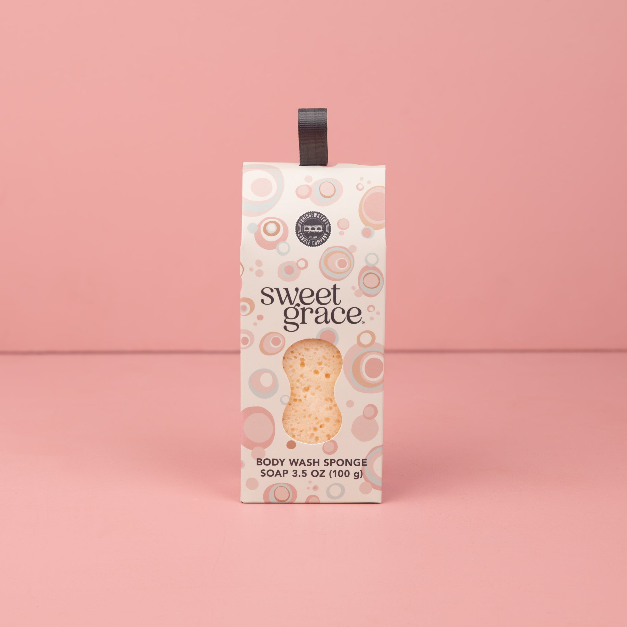 Sweet Grace Body Wash Sponge standing upright against a pink background