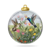 Clear glass ornament painted with two hummingbirds over pink, orange, and purple wildflowers