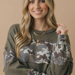 Olive French terry pullover with camo color block sleeves, side view showing slit hem