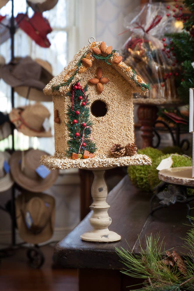 Juniper seed birdhouse displayed on a stand