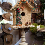 Juniper seed birdhouse displayed on a stand
