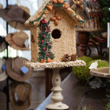 Juniper seed birdhouse displayed on a stand