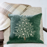 Green pillow with embroidered Christmas tree and pearl ornaments