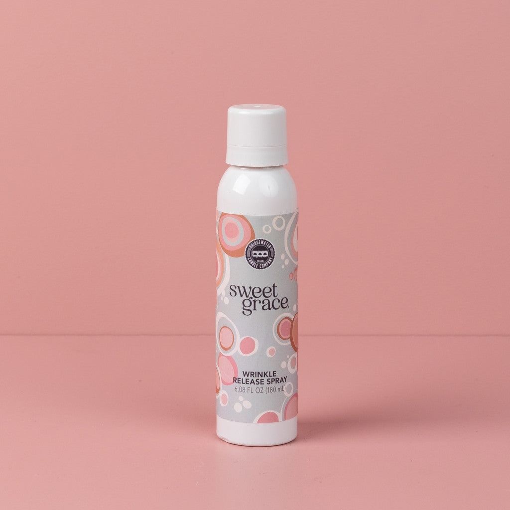 Sweet Grace Wrinkle Release Spray bottle standing on a pink surface