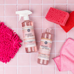 Bridgewater Sweet Grace multi-surface cleaner bottles with pink cleaning cloths and a sponge on a tiled counter