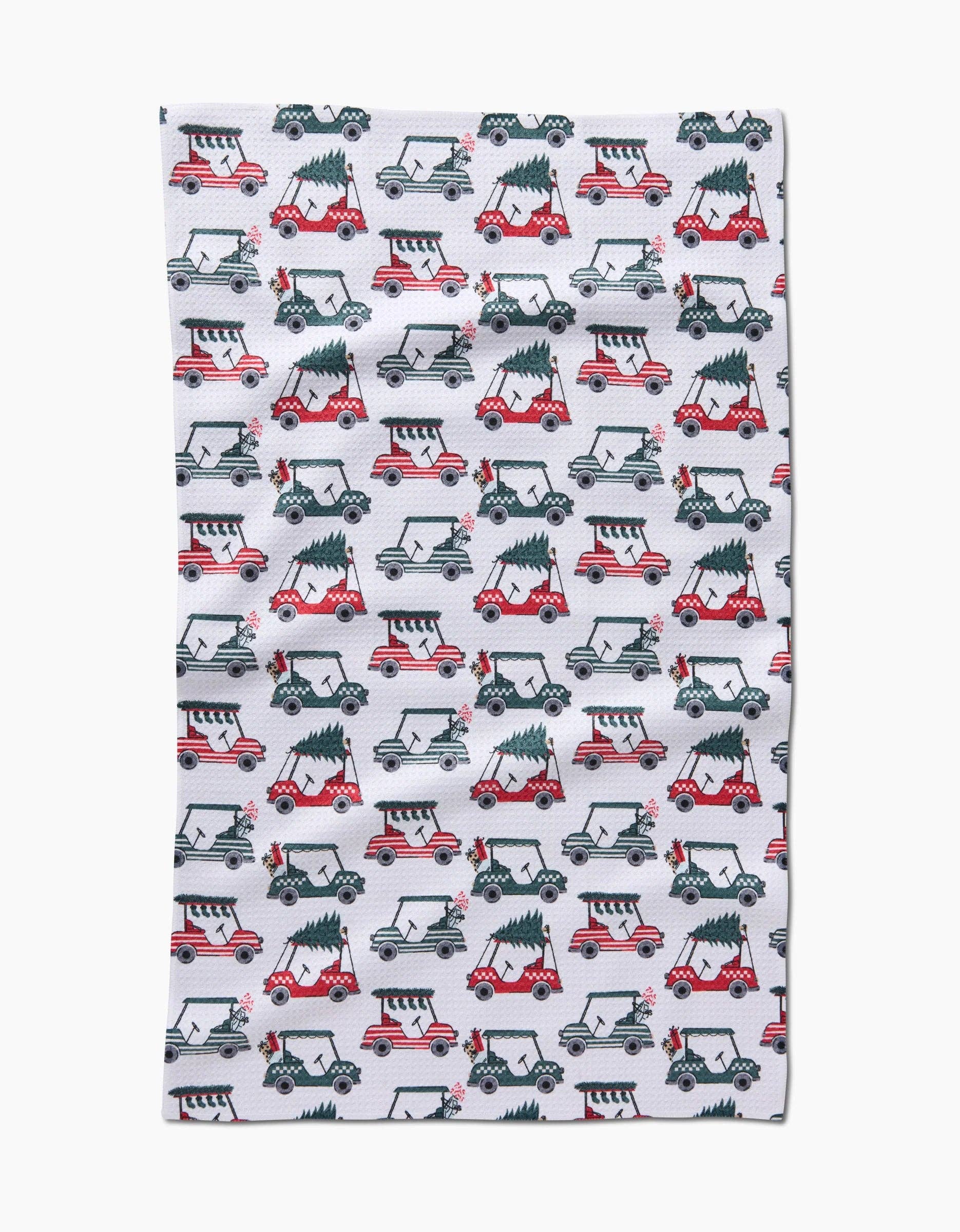 Holiday golf tea towel with golf carts carrying Christmas trees