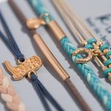Stride hair tie bracelet set in blue, brown, cream and teal with gold cowboy boot and horseshoe charms, view 3